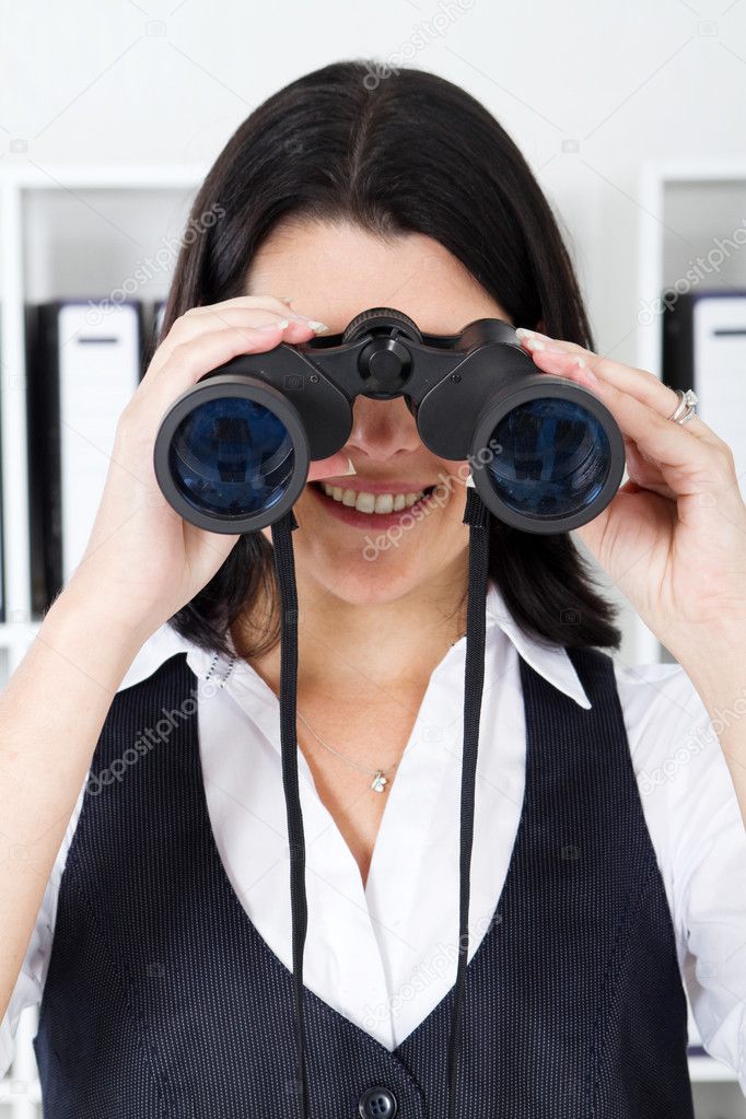 Businesswoman using binoculars