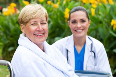 Friendly doctor and senior patient outdoors clipart