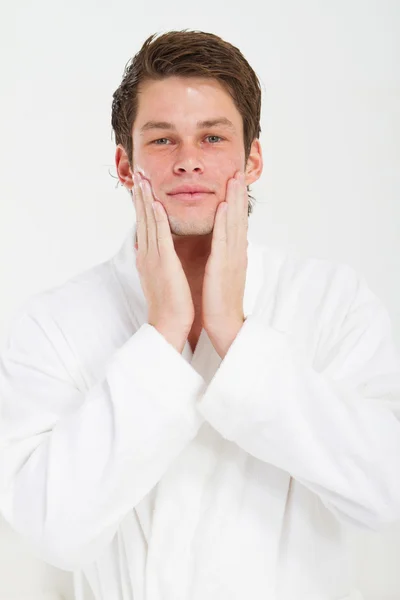 Man with happy smile applying moisturizing lotion — Stock Photo, Image