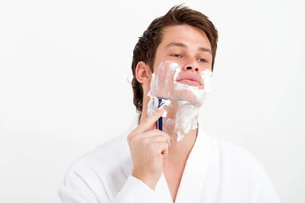 Handsome young man shaving — Stock Photo, Image