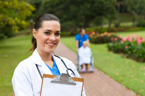 Friendly female doctor portrait outdoors — Stock Photo, Image