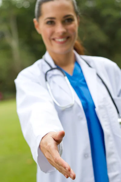 Friendly female doctor handshake outdoors — Stock Photo, Image