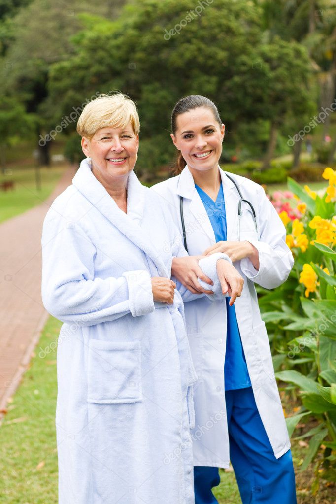 Caring doctor taking senior patient outdoors