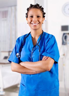 Happy african american nurse in hospital clipart