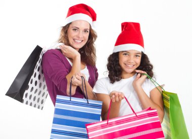 Happy mother and daughter with Christmas shopping bags clipart