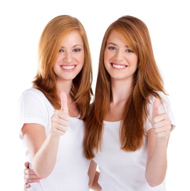 Happy teen sisters giving thumbs up clipart