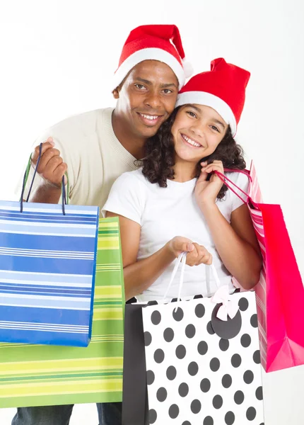 Vader en dochter met Kerstmis shopping tassen — Stockfoto