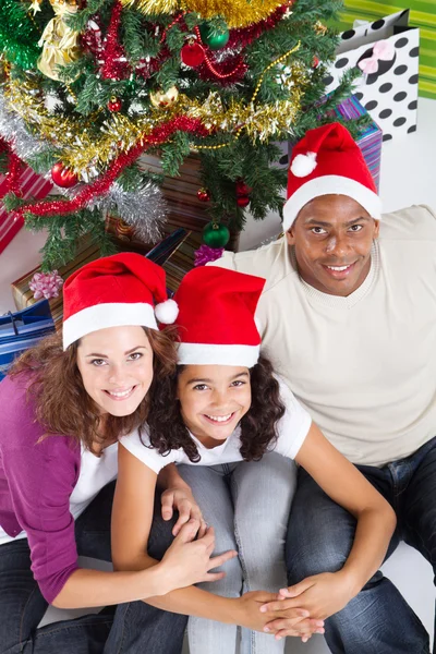 Ευτυχισμένη οικογένεια κάθεται κοντά στο χριστουγεννιάτικο δέντρο — Φωτογραφία Αρχείου