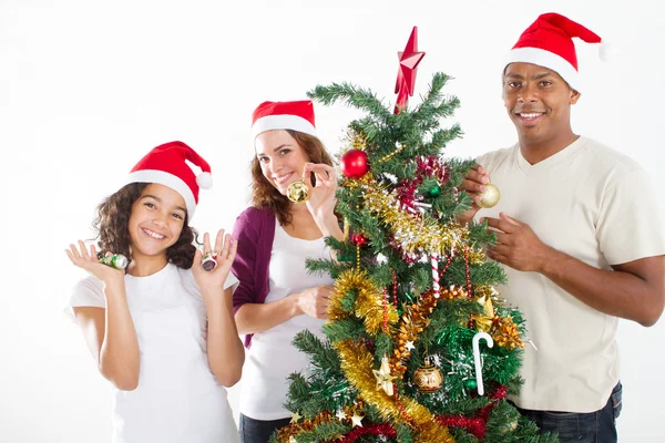 Happy multiracial family decorating Christmas tree — Stock Photo, Image