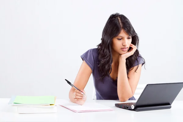 Young female university student studying in classroom — Stock Photo, Image