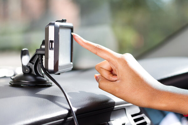 Finger pointing at car GPS navigation system