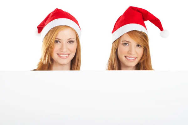 Meninas de Natal bonitas segurando uma placa branca — Fotografia de Stock