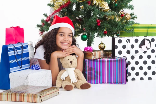 Cute little girl with presents near a christmas tree Stock Image