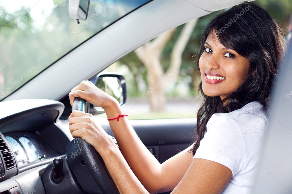 Young indian woman driving a car