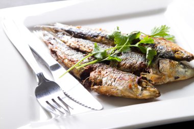 Fried sardine on plate clipart