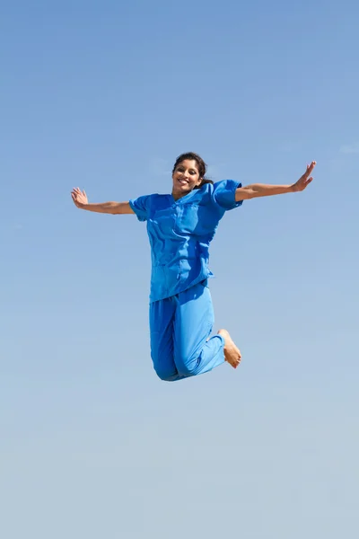 Cheerful medical nurse jumping up — Stock Photo, Image