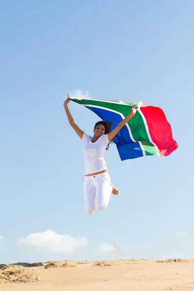 South african flag and jumping on beach — Stock Photo, Image