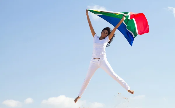 Jovem com bandeira sul-africana e pulando — Fotografia de Stock