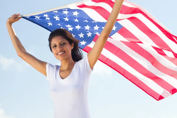 Happy young woman holding american flag — Stock Photo, Image