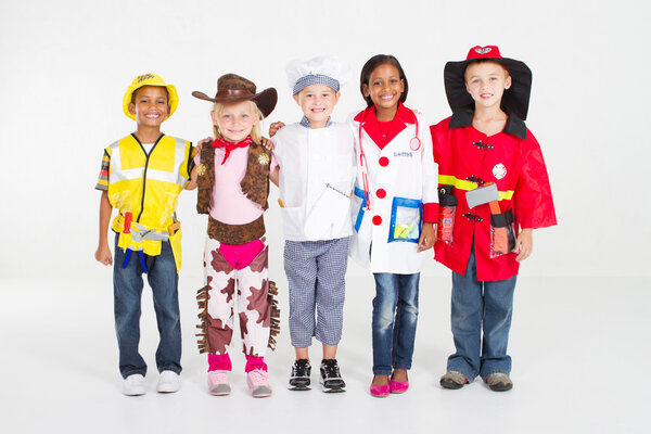 Group of children dressing in various uniforms