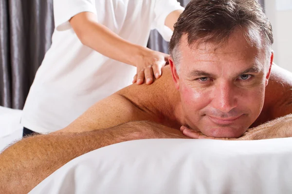 Mature man having massage — Stock Photo, Image