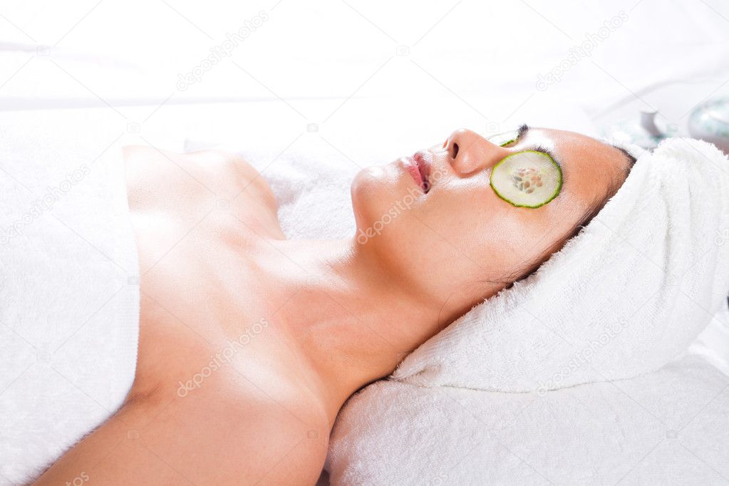 Asian woman with a facial cucumber mask