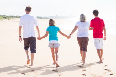 Family walking on beach clipart