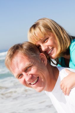 Father giving piggyback ride to daughter clipart