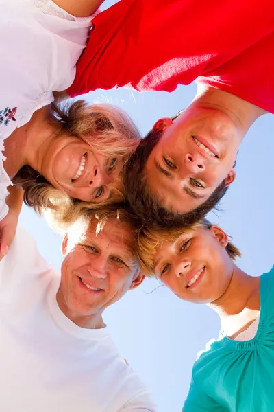 Below angle of happy family embracing — Stock Photo, Image