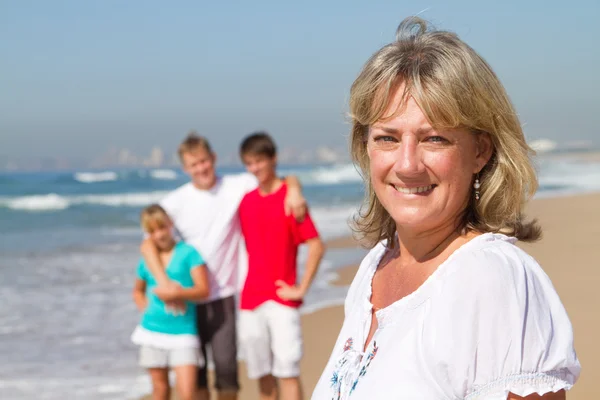 Feliz meia idade mãe e família na praia — Fotografia de Stock