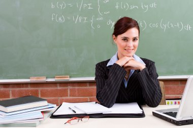 Beautiful female teacher in classroom clipart