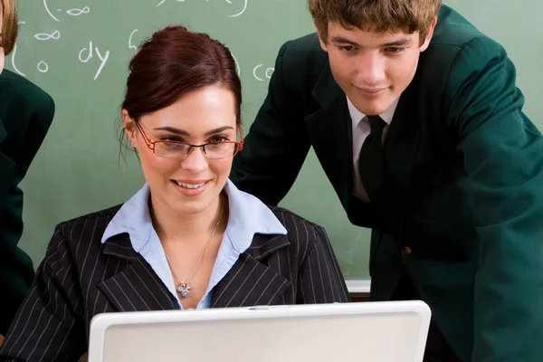 Onderwijzer en student met behulp van computer — Stockfoto
