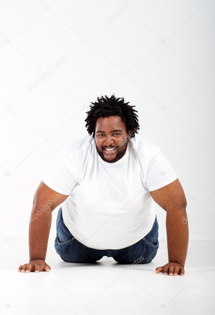 Funny fat african man lying on floor Stock Photo by ©michaeljung 11428433