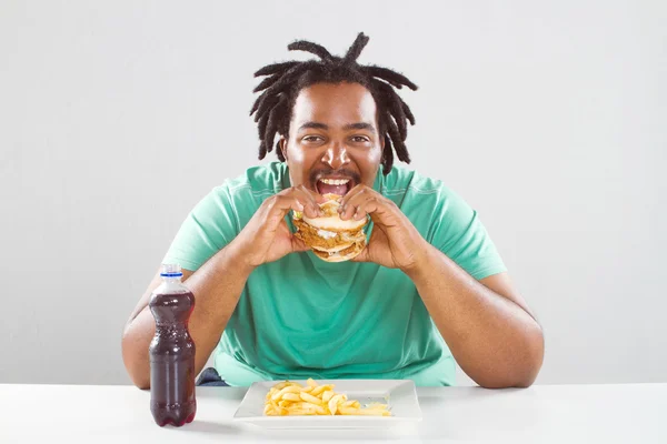 stock image Happy fat african american man eating a hamburger