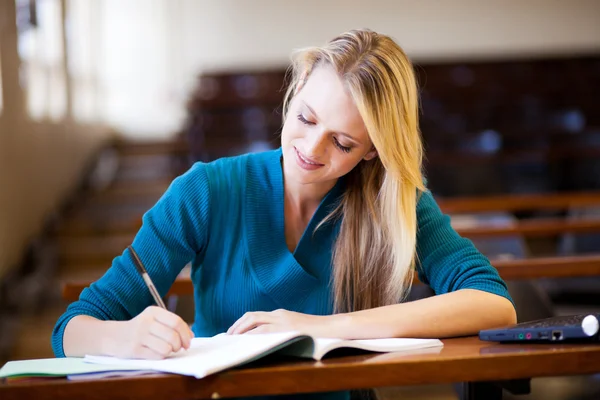 Young female college girl in lecture room — Stock Photo, Image