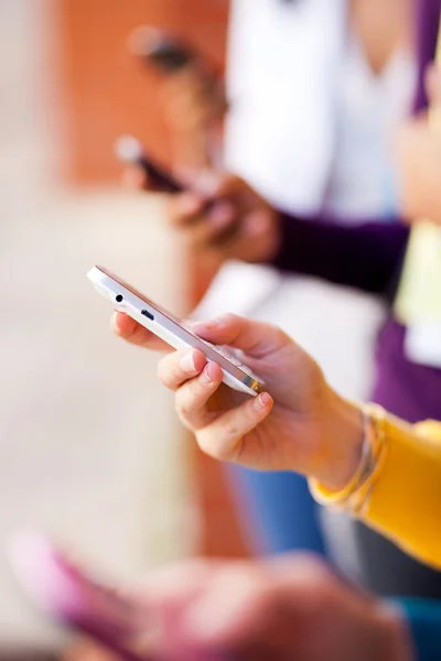 Group of young using smart phone — Stock Photo, Image
