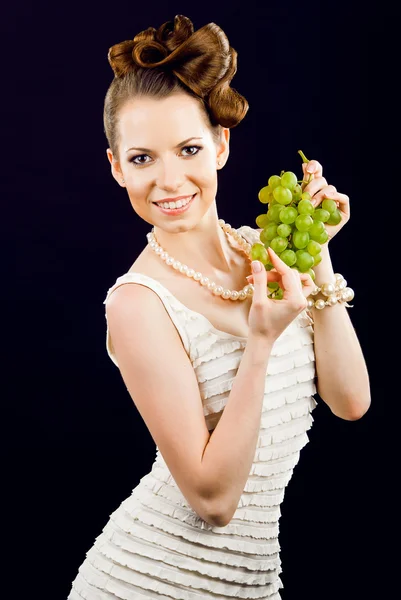 Beautiful girl holding grapes — Stock Photo, Image