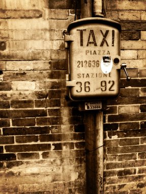 Vintage taxi sign on brick wall clipart