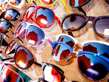 Rack with an assortment of sunglasses clipart