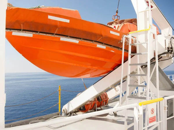 Stock image Orange lifeboat on deck of cruise ship