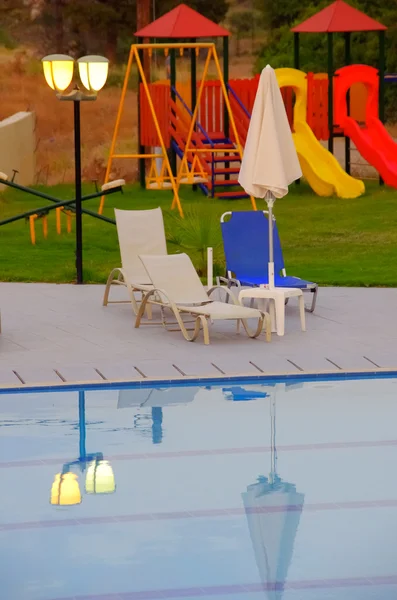 stock image Poolside loungers and childrens playground