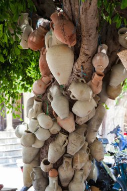 Hanging pots at market, a traditional pottery Tunisia clipart