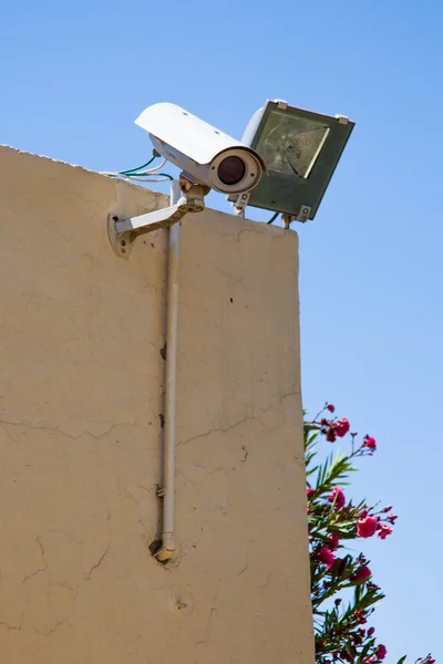 stock image Video camera of system of supervision on a building wall