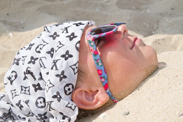 Boy buried in sand — Stock Photo, Image