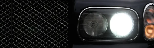 Part of brutal car face, light in darkness — Stok fotoğraf