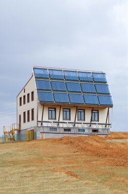 Eco-house with solar panels clipart