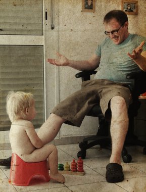 Child on potty play with father. Photo in old image style. clipart