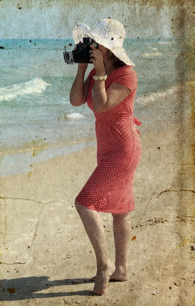 Young girl in red dress with old camera — Stock Photo, Image