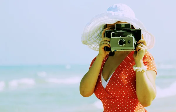 Young girl in red dress with old camera — Stock Photo, Image