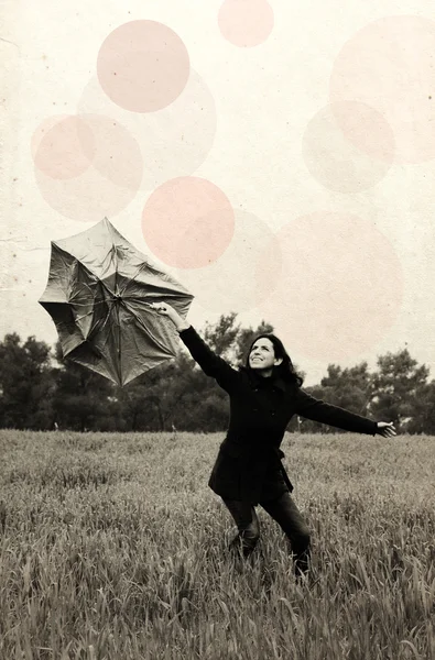 Young woman with umbrella. Photo in old color image style. — Stock Photo, Image